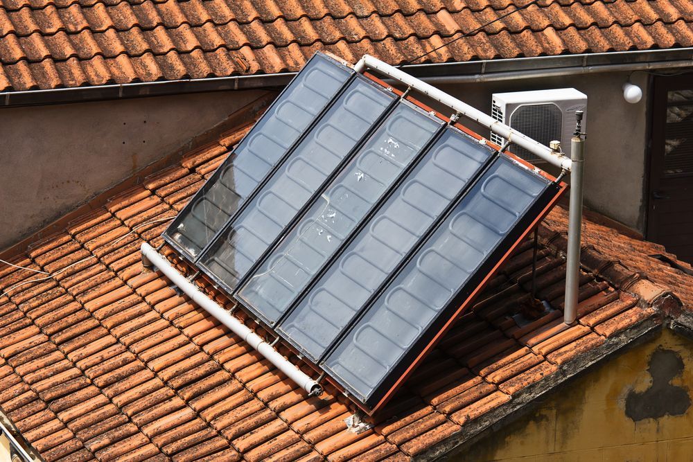 Roof Mounted Solar Water Heater on A Red Tiled Roof — Enterprise Air That's Cool In Svensson Heights, QLD