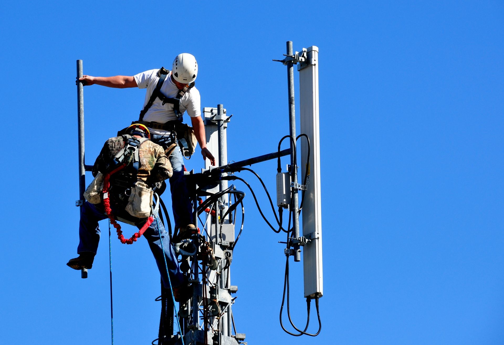 Two Workers in Safety Gear Climbing and Repairing a Cell Tower — Enterprise Air That's Cool In Svensson Heights, QLD