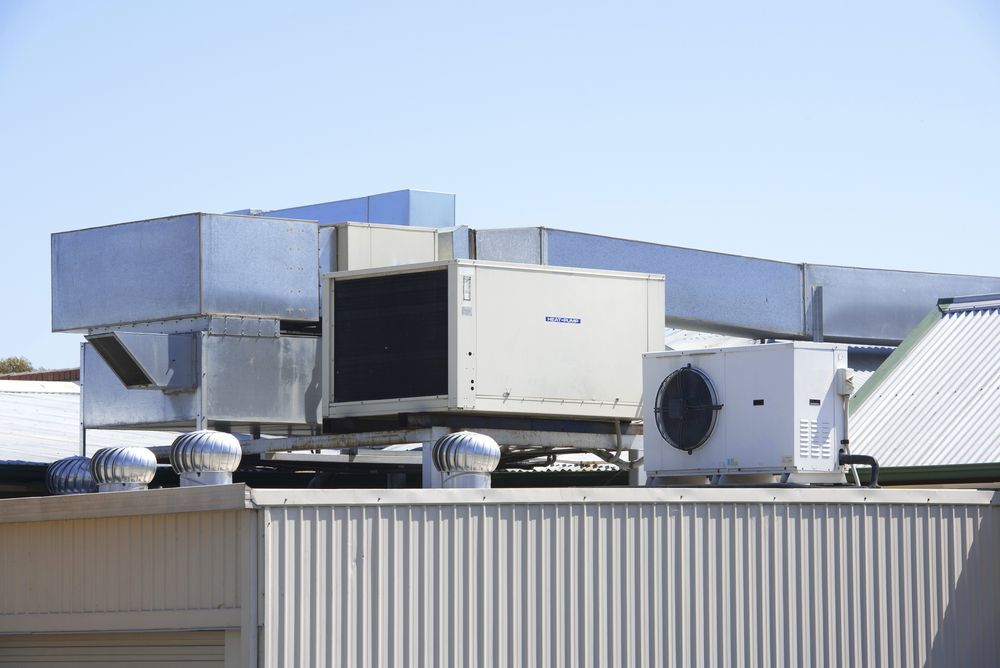 Rooftop HVAC Units and Ductwork Atop a Commercial Building — Enterprise Air That's Cool In Svensson Heights, QLD