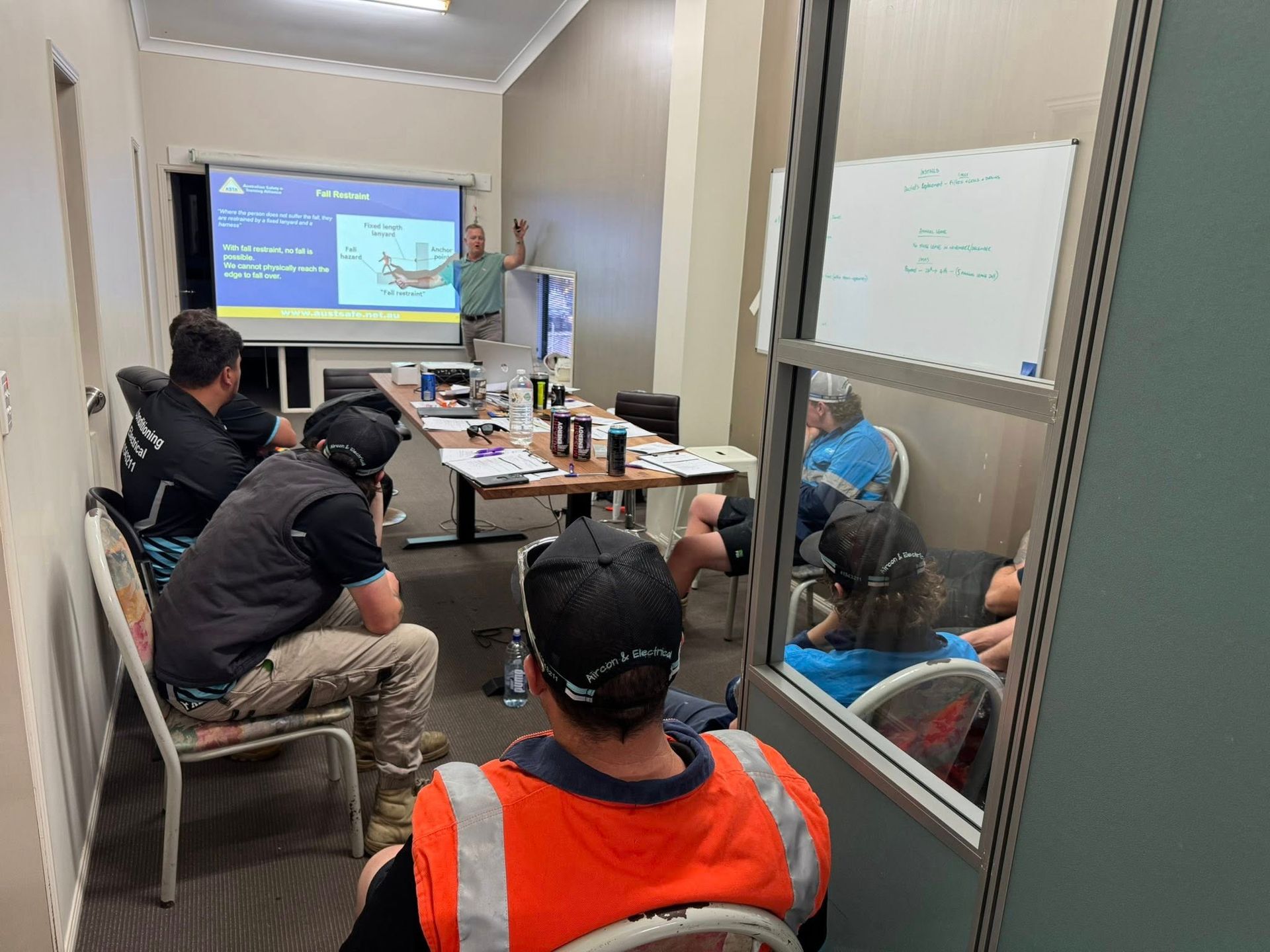 Small Meeting Room with Five People Seated Around a Table — Enterprise Air That's Cool In Svensson Heights, QLD.