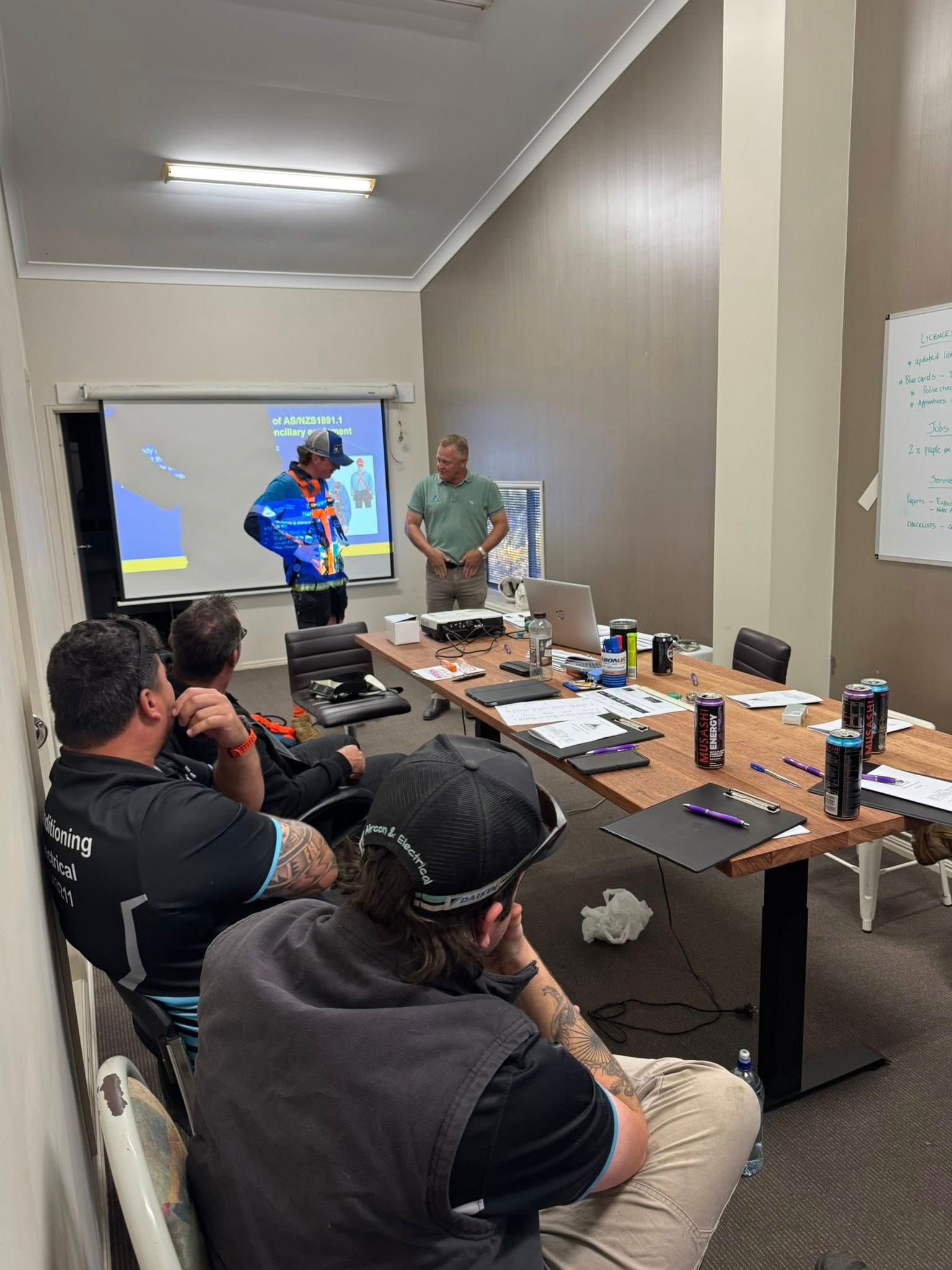 People Seated in A Small Meeting Room Watching a Presentation — Enterprise Air That's Cool In Svensson Heights, QLD