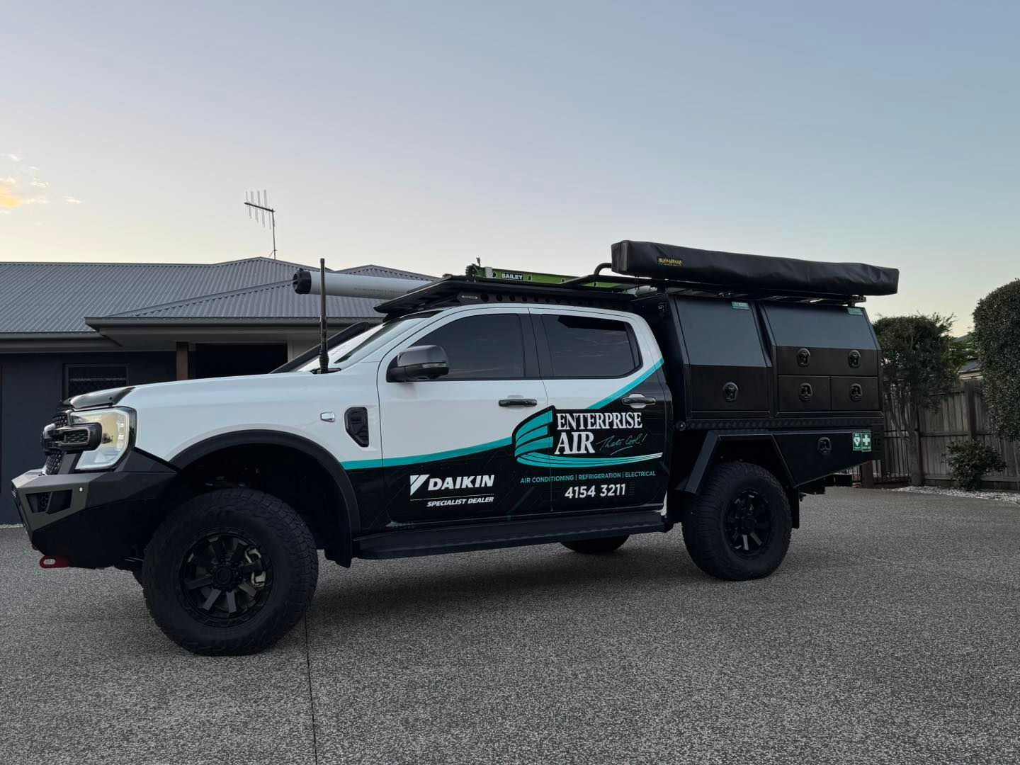 Black and White Off-Road Truck with Rooftop Gear — Enterprise Air That's Cool In Svensson Heights, QLD