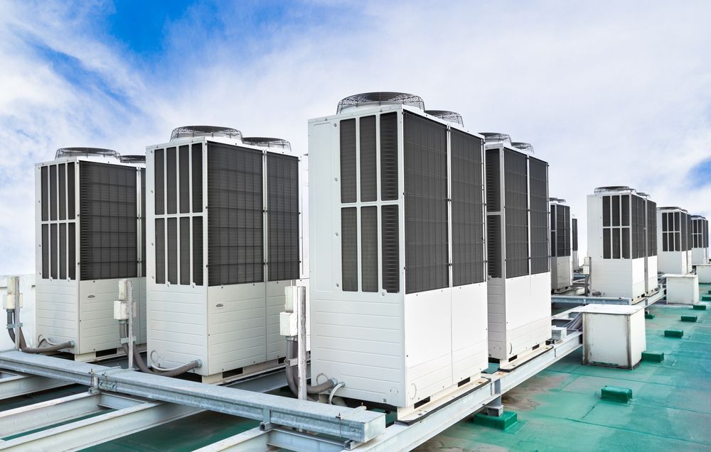 Row of Large Rooftop HVAC Units on a Green Industrial Roof — Enterprise Air That's Cool In Woodgate, QLD