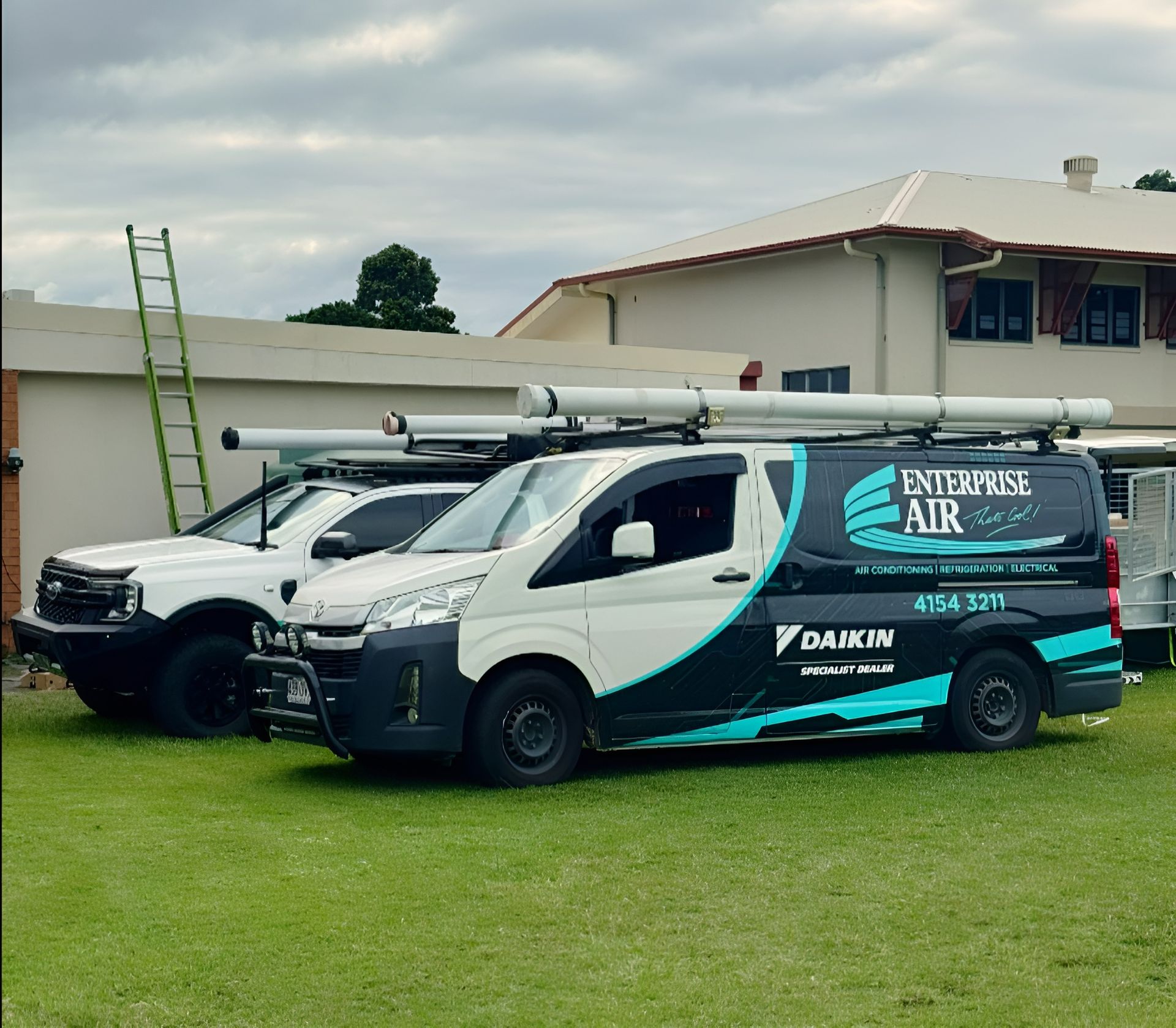 Two Enterprise Air Service Vans Parked on A Grassy Lawn — Enterprise Air That's Cool In Svensson Heights, QLD