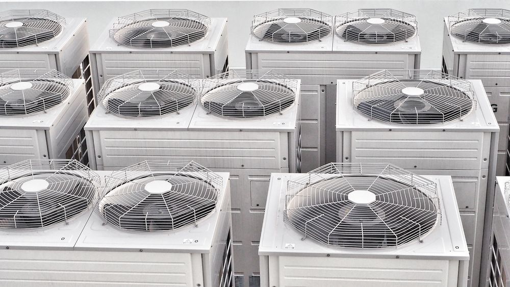 Rows of White Outdoor Air Conditioning Units — Enterprise Air That's Cool In Woodgate, QLD