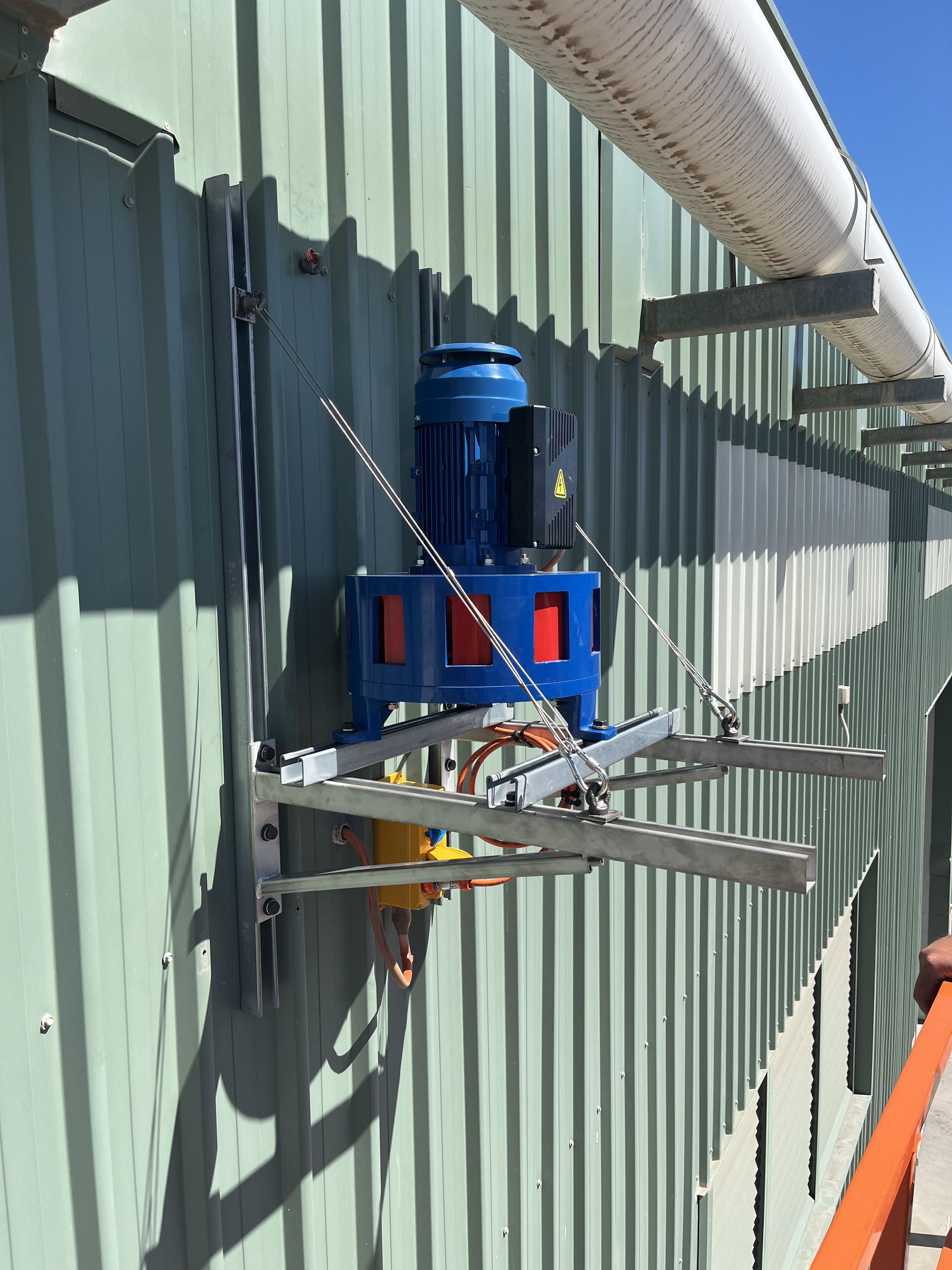 Blue Industrial Machine Mounted on a Corrugated Metal Wall — Enterprise Air That's Cool In Svensson Heights, QLD