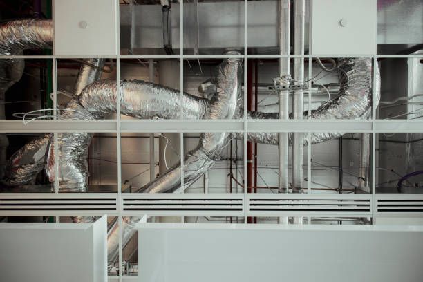Silver Hvac Ductwork Behind a Metal Grid — Enterprise Air That's Cool In Svensson Heights, QLD
