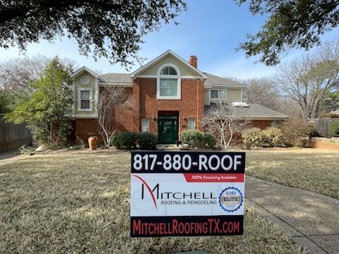 Brick house with a Mitchell Roofing sign in the front yard and phone number 817-880-ROOF.