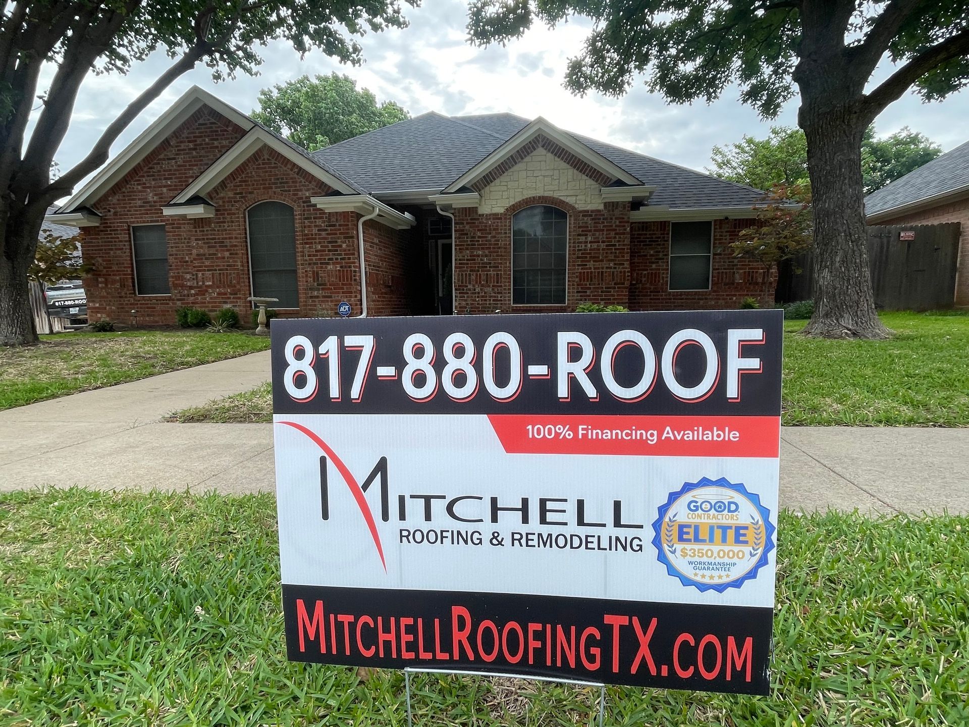 Red tiled roof with chimney topped by a small, decorative roof with a golden sphere finial.