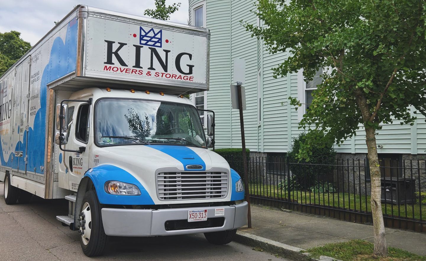 A king moving truck is parked on the side of the road.