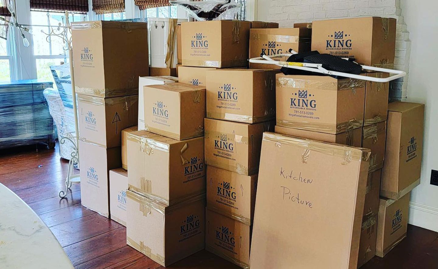 A pile of cardboard boxes stacked on top of each other in a room.