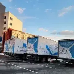 Two closed van trucks of King Affordable Movers