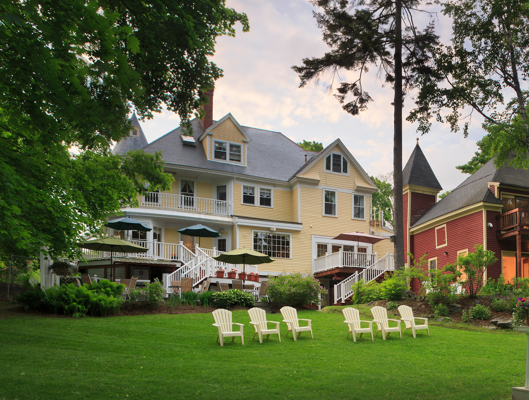 A large house with a lot of chairs in front of it