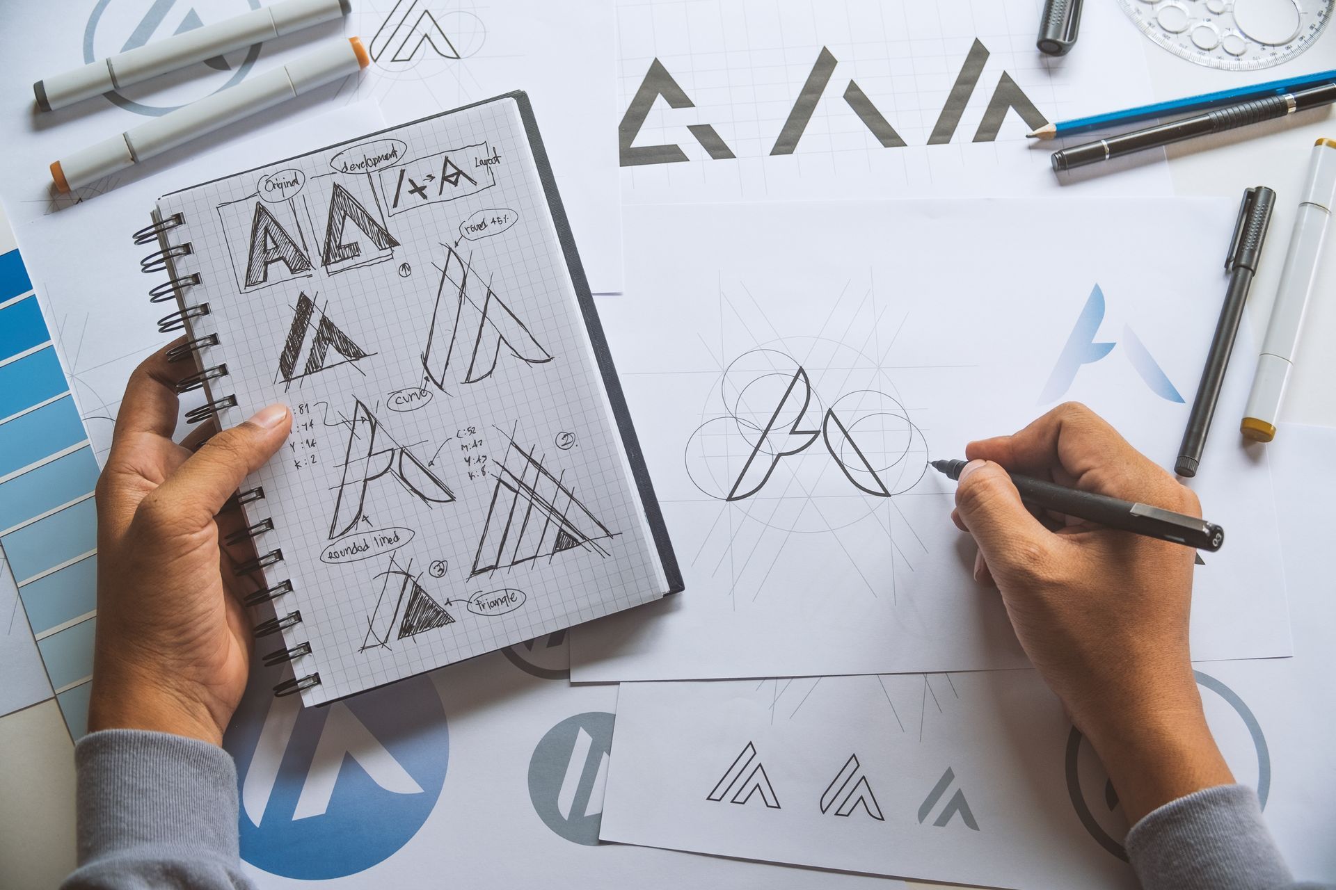 first-person perspective of someone designing a logo by hand