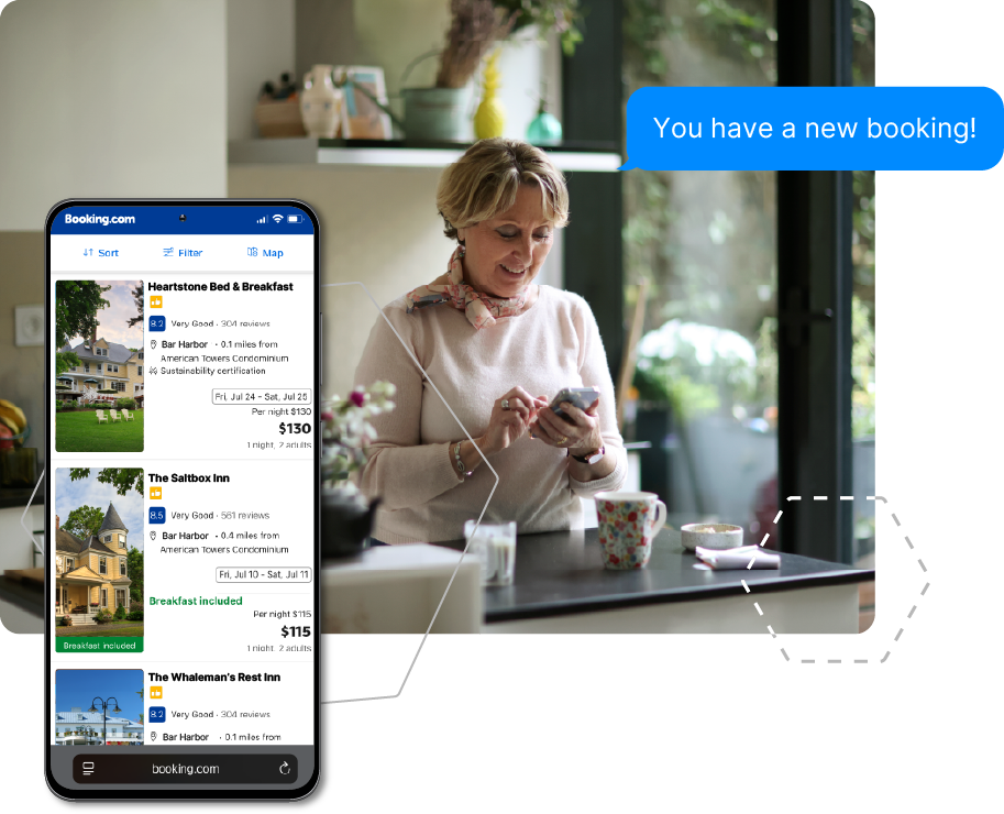 Woman at a bed and breakfast looking at her phone with a “You have a new booking!” notification.