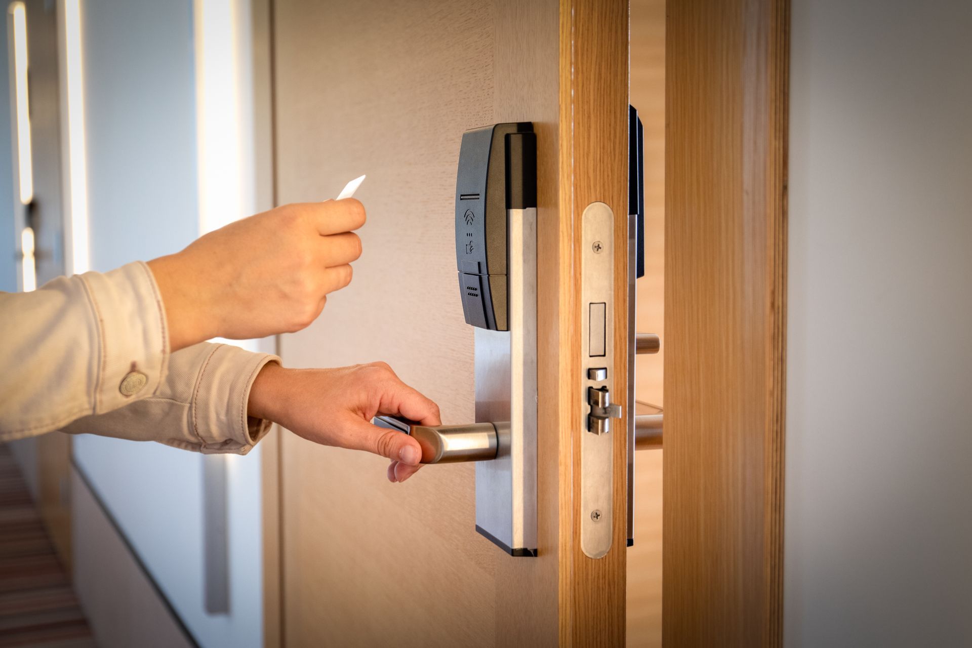 A person is opening a door with a key card.
