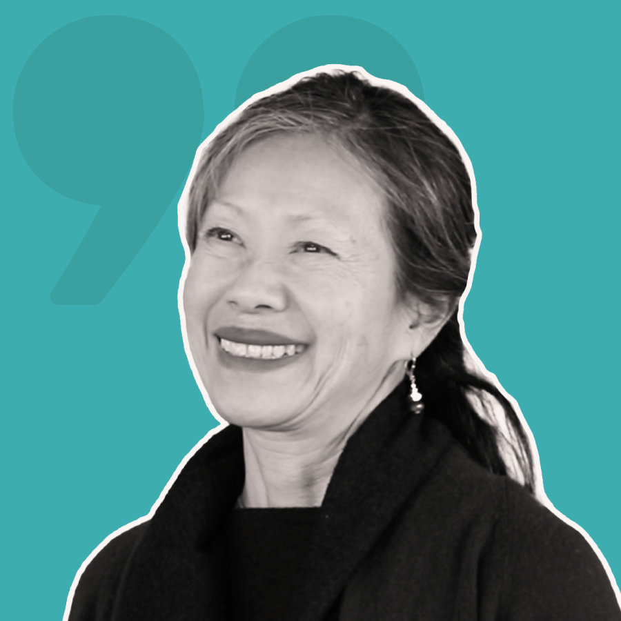 A woman is smiling in a black and white photo