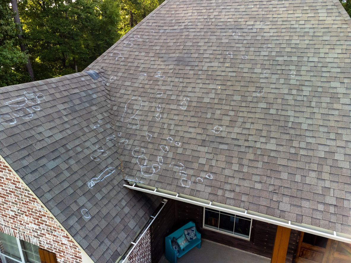 An aerial view of a house with a roof and a porch.