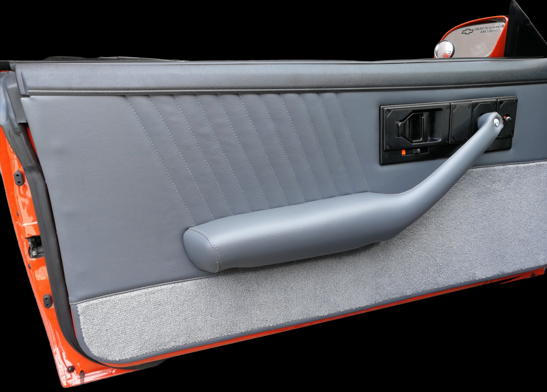 Gray car door interior with armrest and door handle.