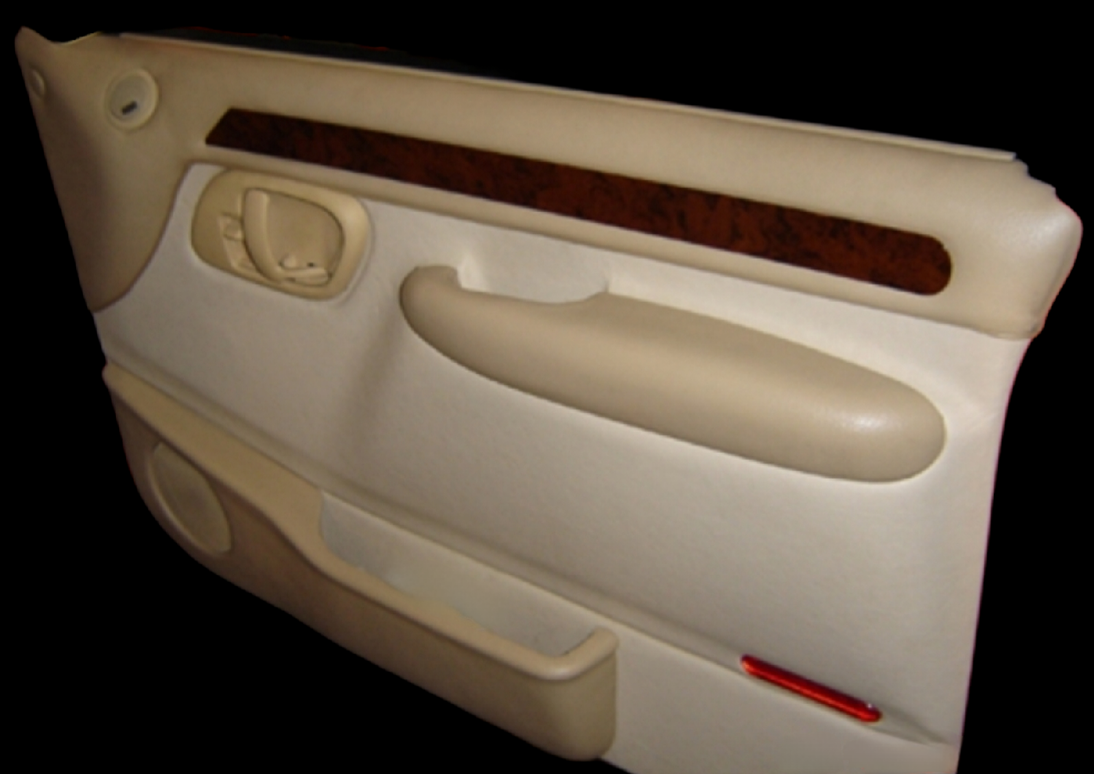 Beige car door panel with wood trim, handle, and red reflector.