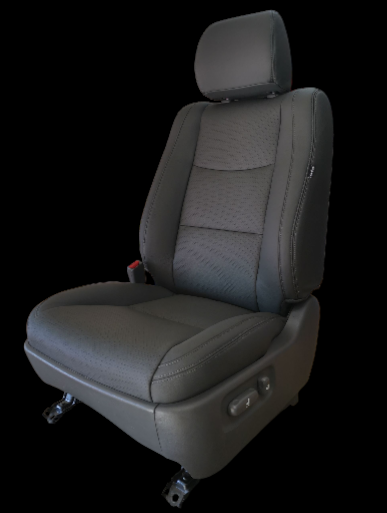 Black car seat with headrest, power adjustments, and seat belt, against a black background.