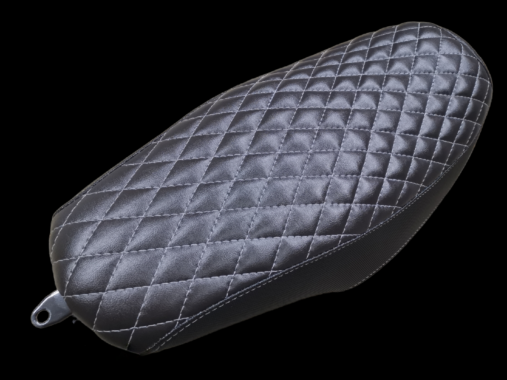 Black motorcycle seat with diamond stitching, metal bracket.