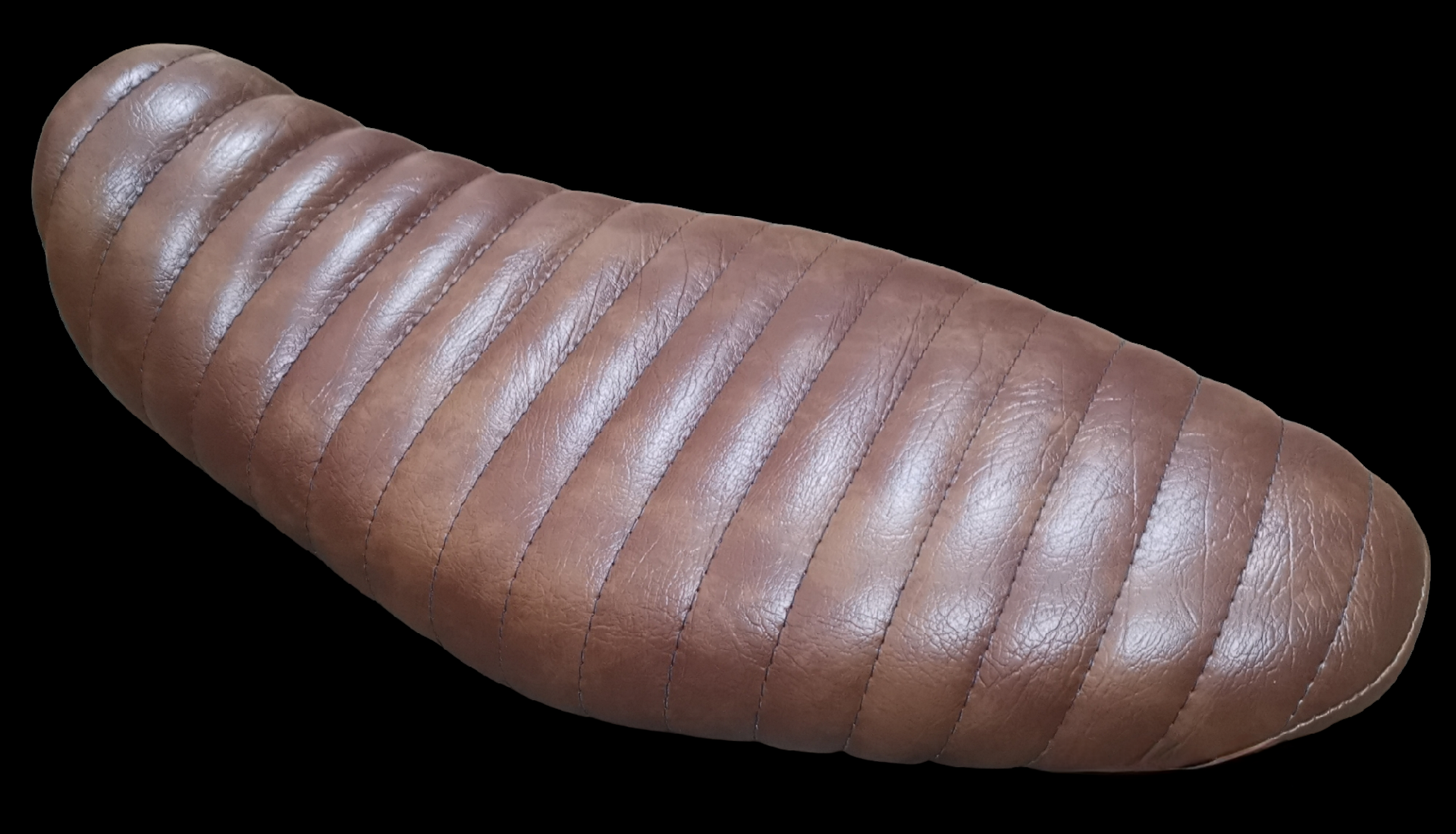 Brown leather motorcycle seat with ribbed padding.