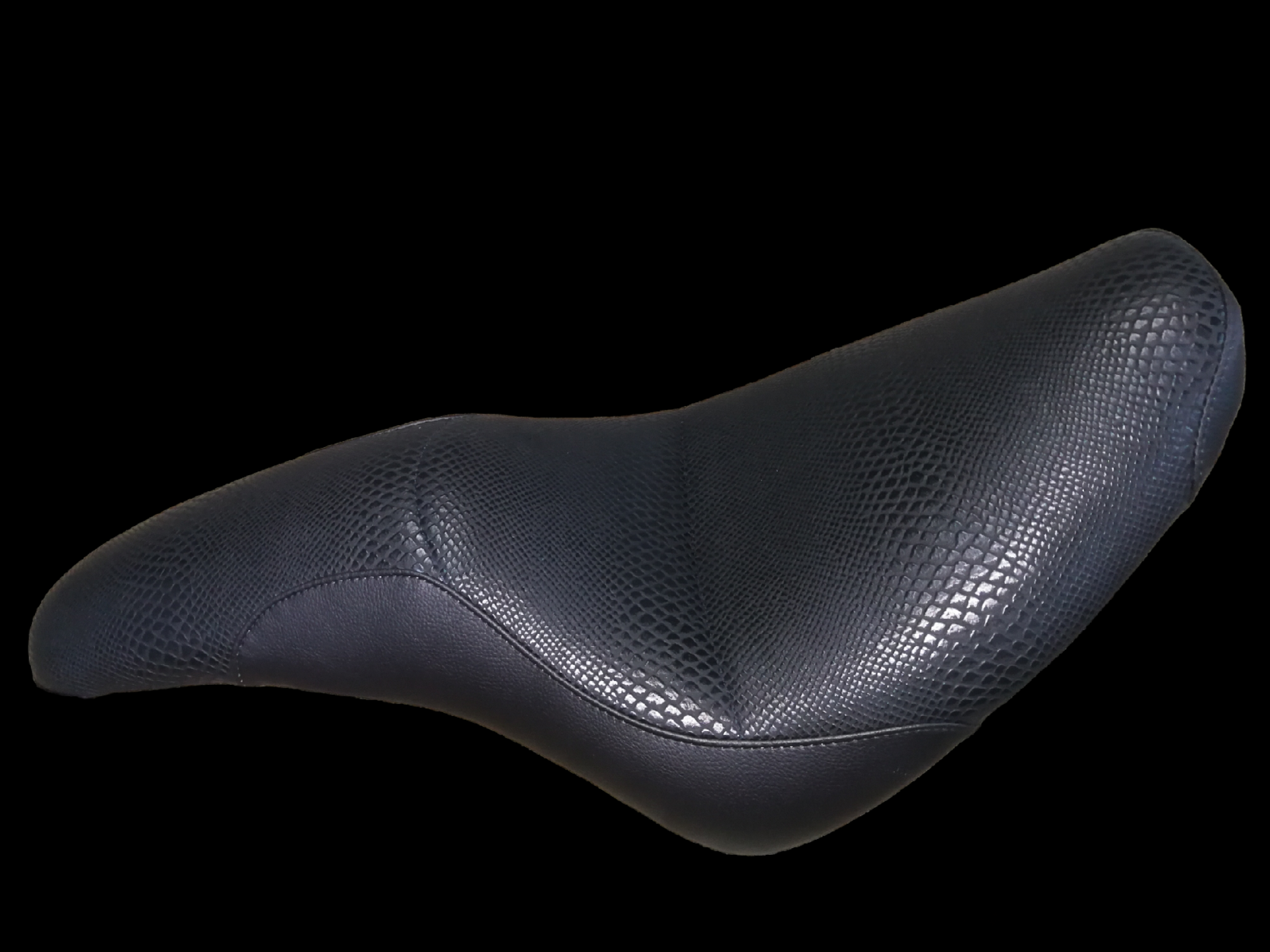 Black motorcycle seat with textured pattern.