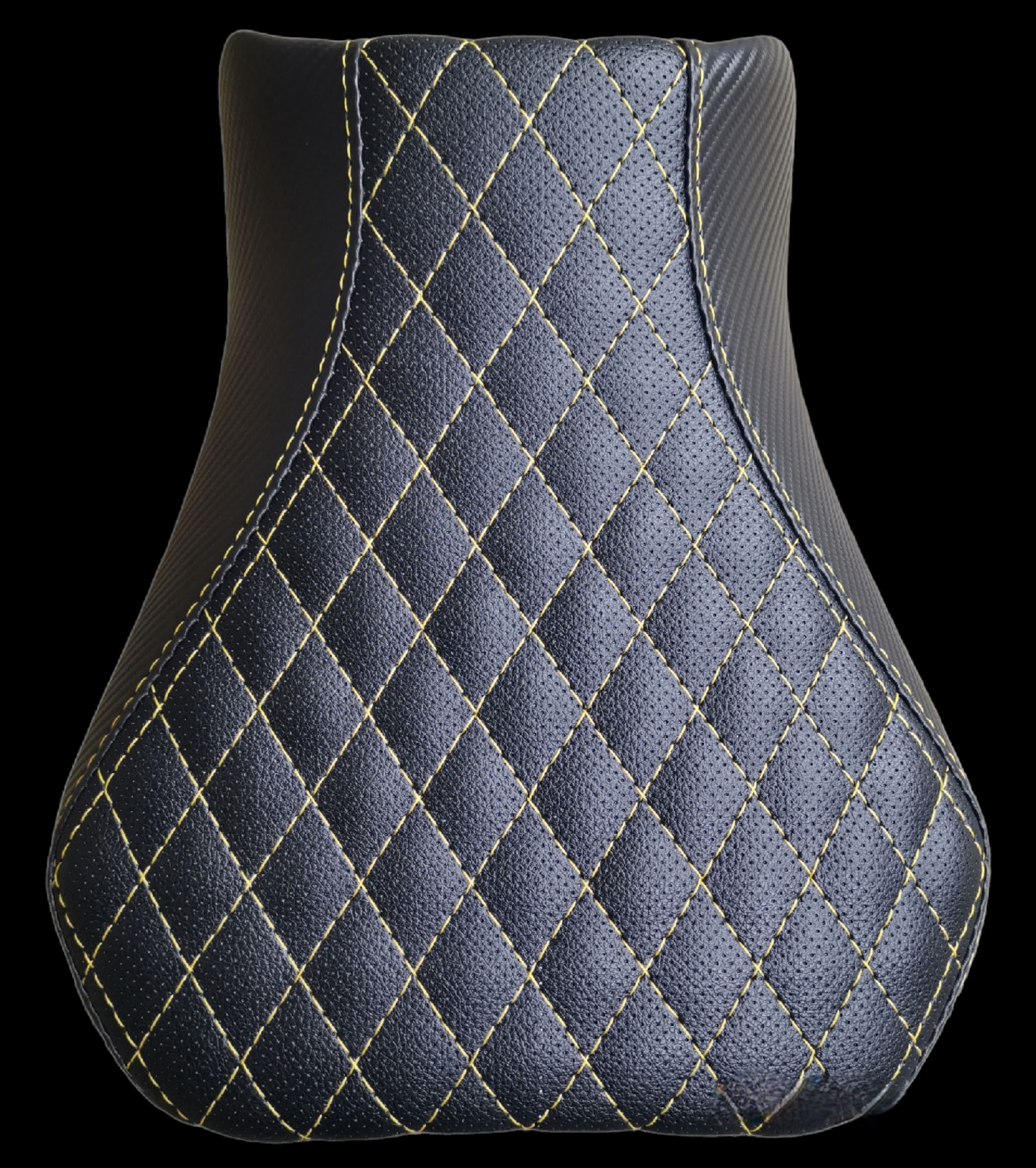 Black motorcycle seat with diamond-stitched pattern and gold stitching.