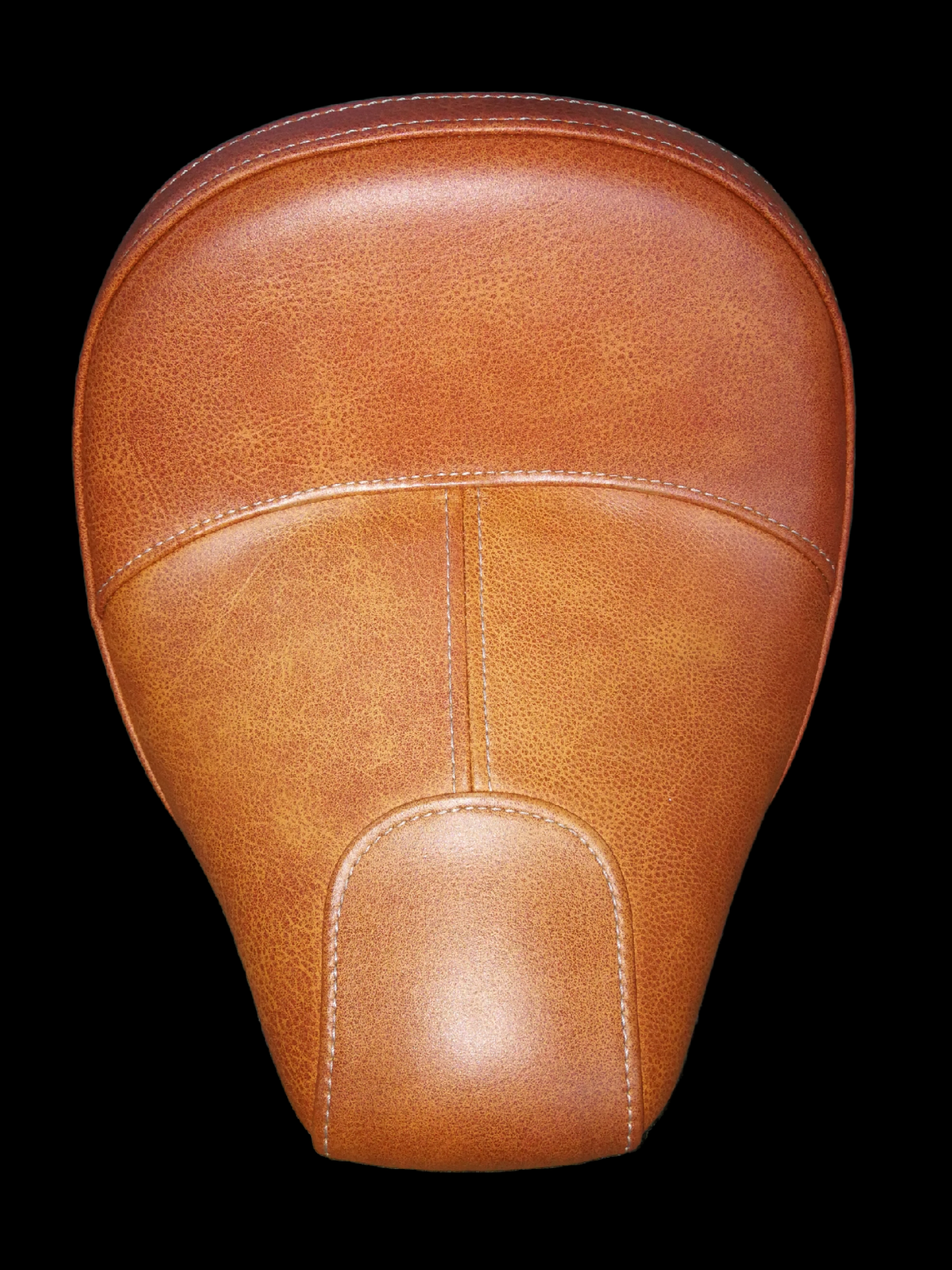 Tan leather motorcycle seat, stitched detailing, on black background.