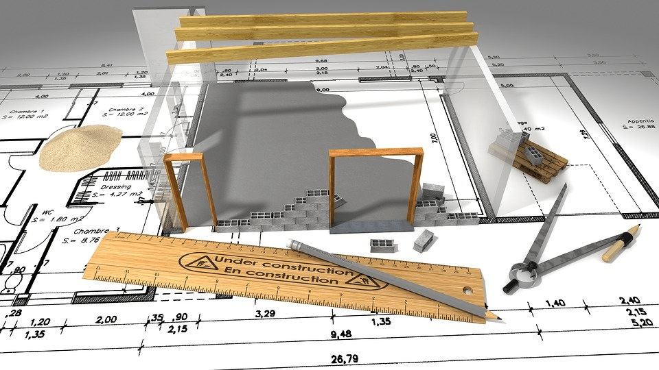 Construction plans with a partially built transparent house, ruler, and drafting tools.
