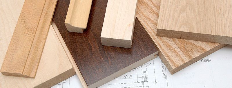 Various wood samples on top of blueprint paper.