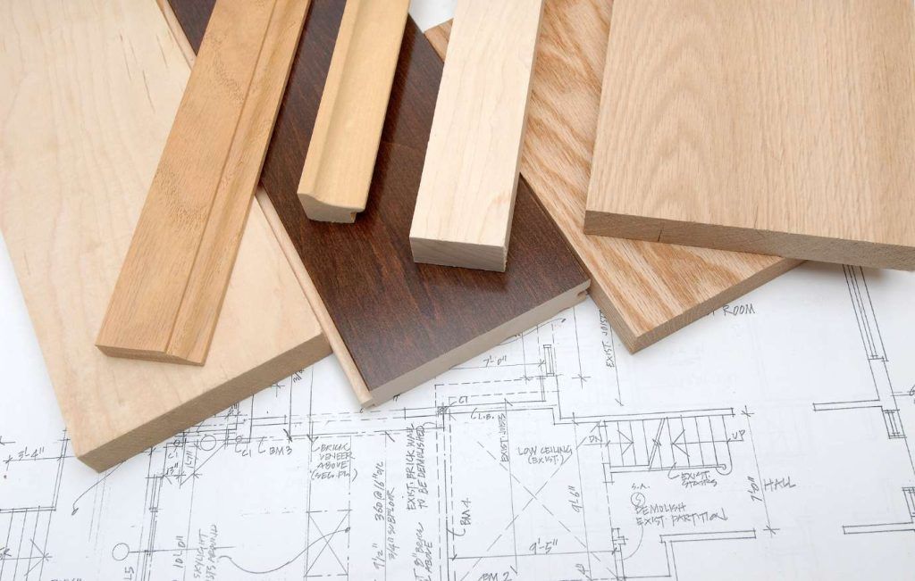 Wood samples in various colors on top of a blueprint.
