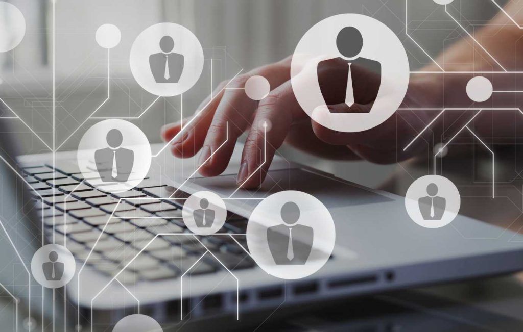 Person using a laptop, with human icons overlaid, representing networking or recruitment.