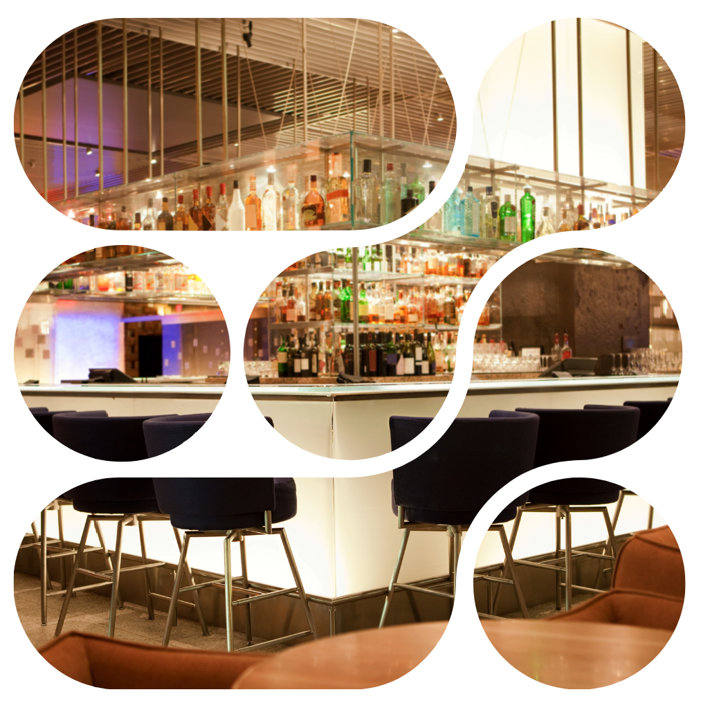 Bar interior with shelves of liquor, blue-cushioned bar stools, and bright lighting.