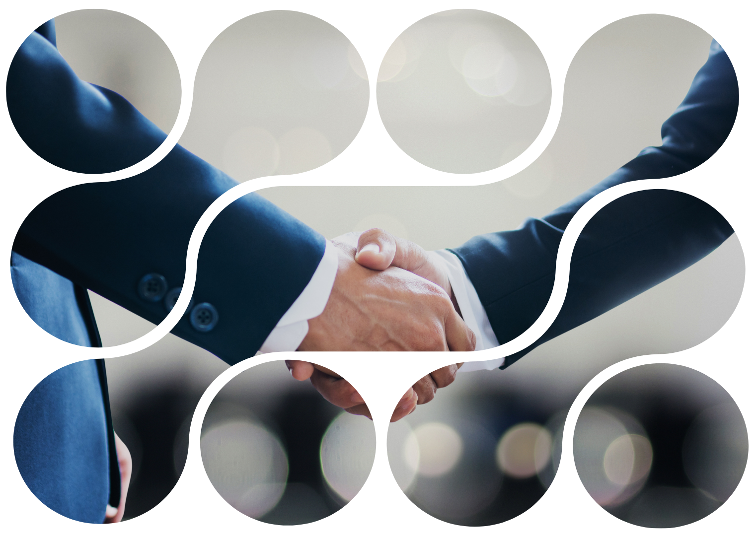 Two people in suits shaking hands; business deal or agreement.