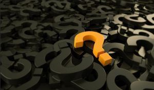 Orange question mark stands out amongst black question marks.