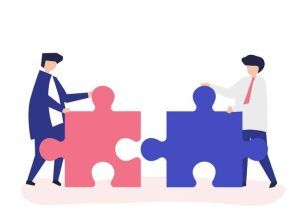 Two men connecting giant puzzle pieces; teamwork and collaboration.