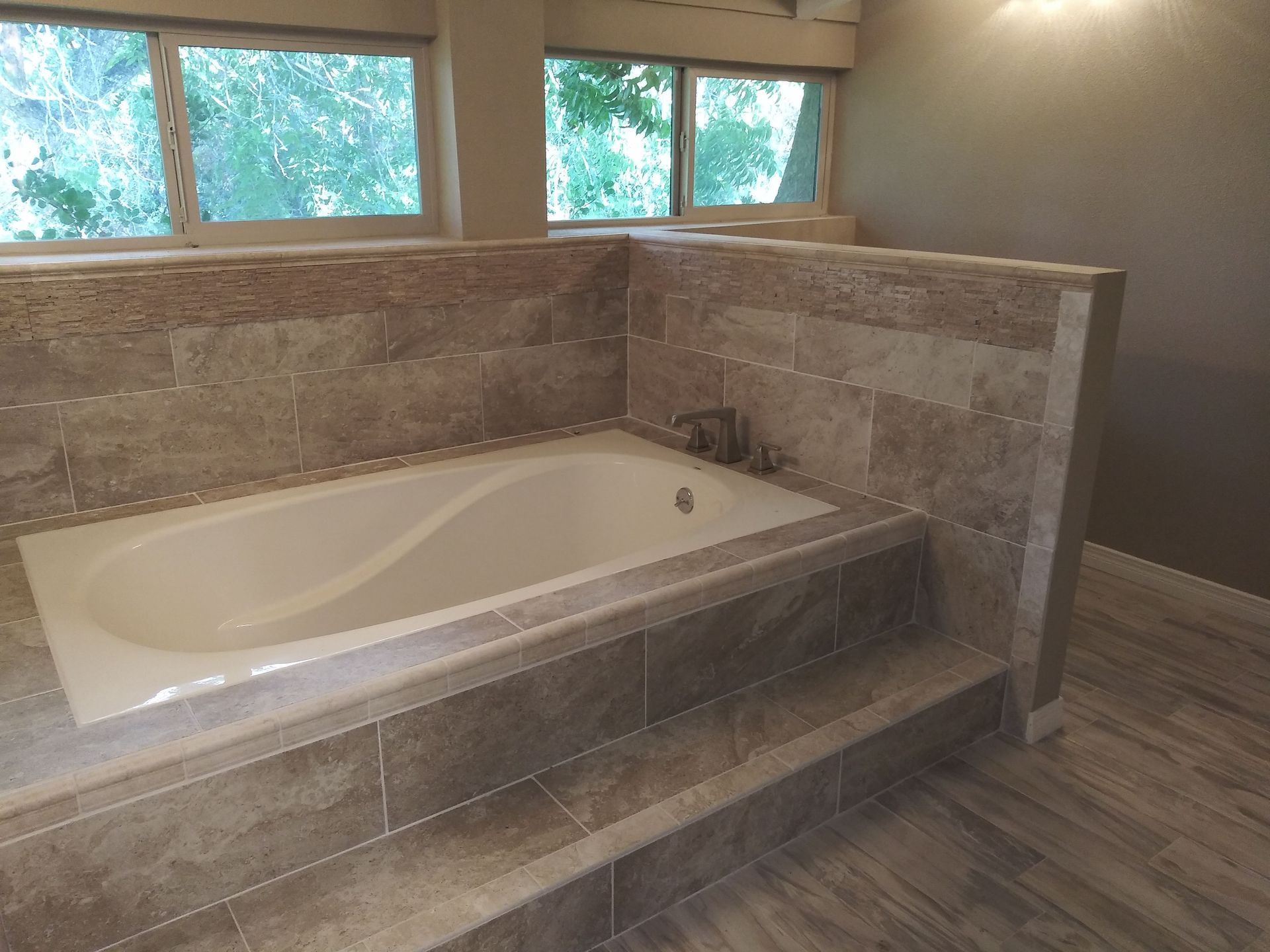 There is a bathtub in the middle of the bathroom.
