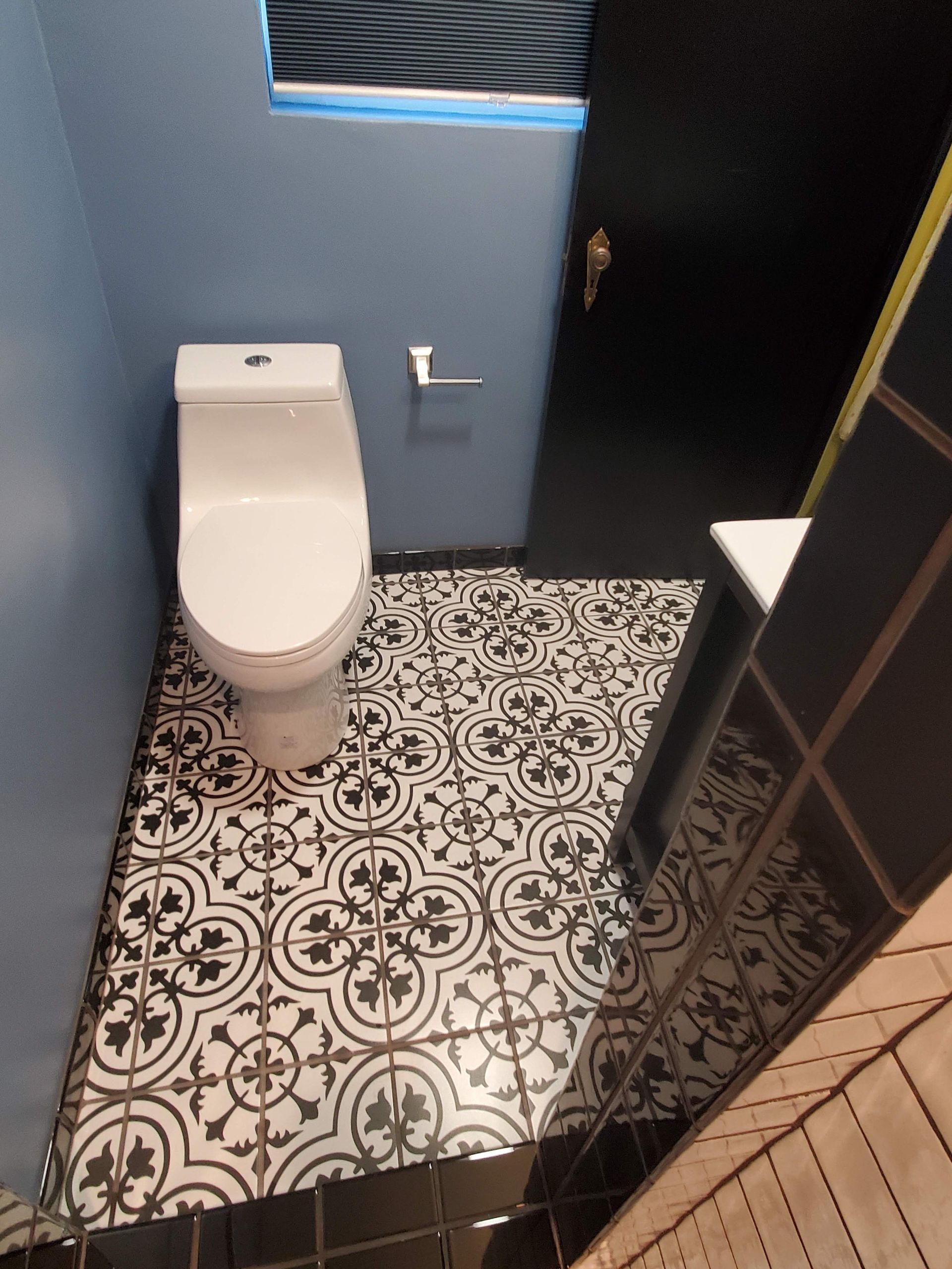 A bathroom with a toilet and a sink in it