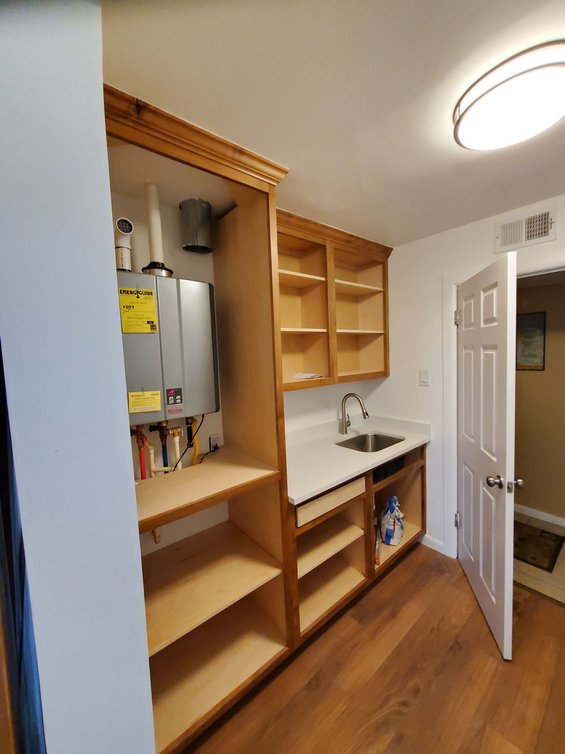 A kitchen with wooden cabinets and a sink