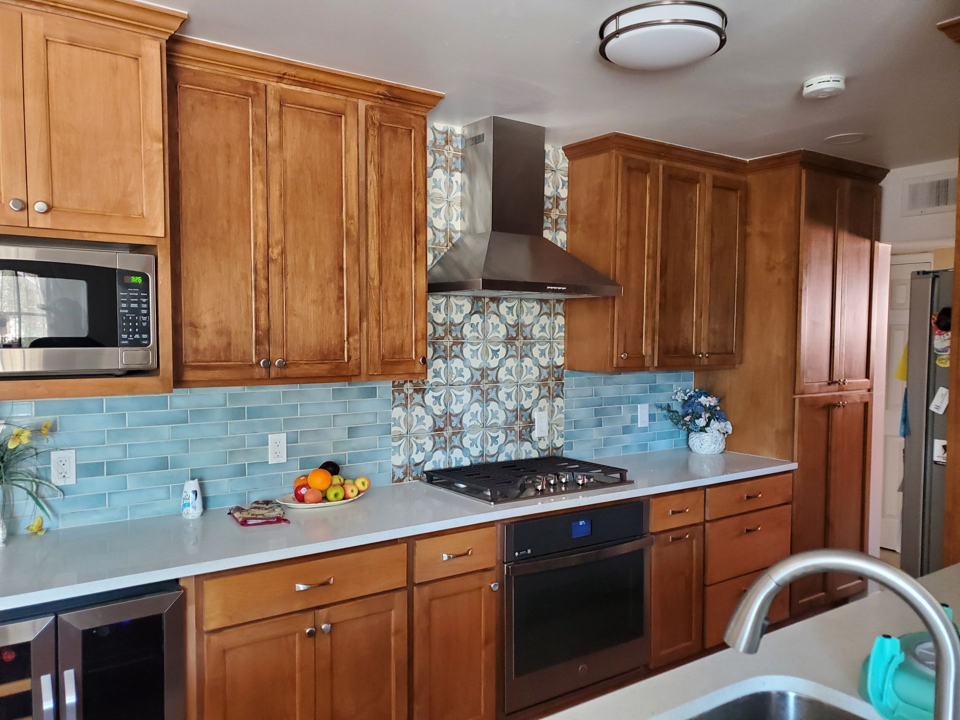 A kitchen with wooden cabinets and stainless steel appliances.