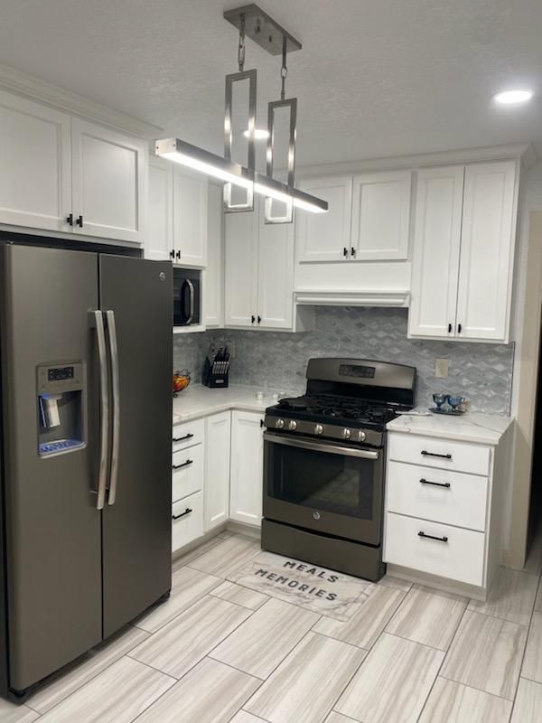A kitchen with stainless steel appliances and white cabinets