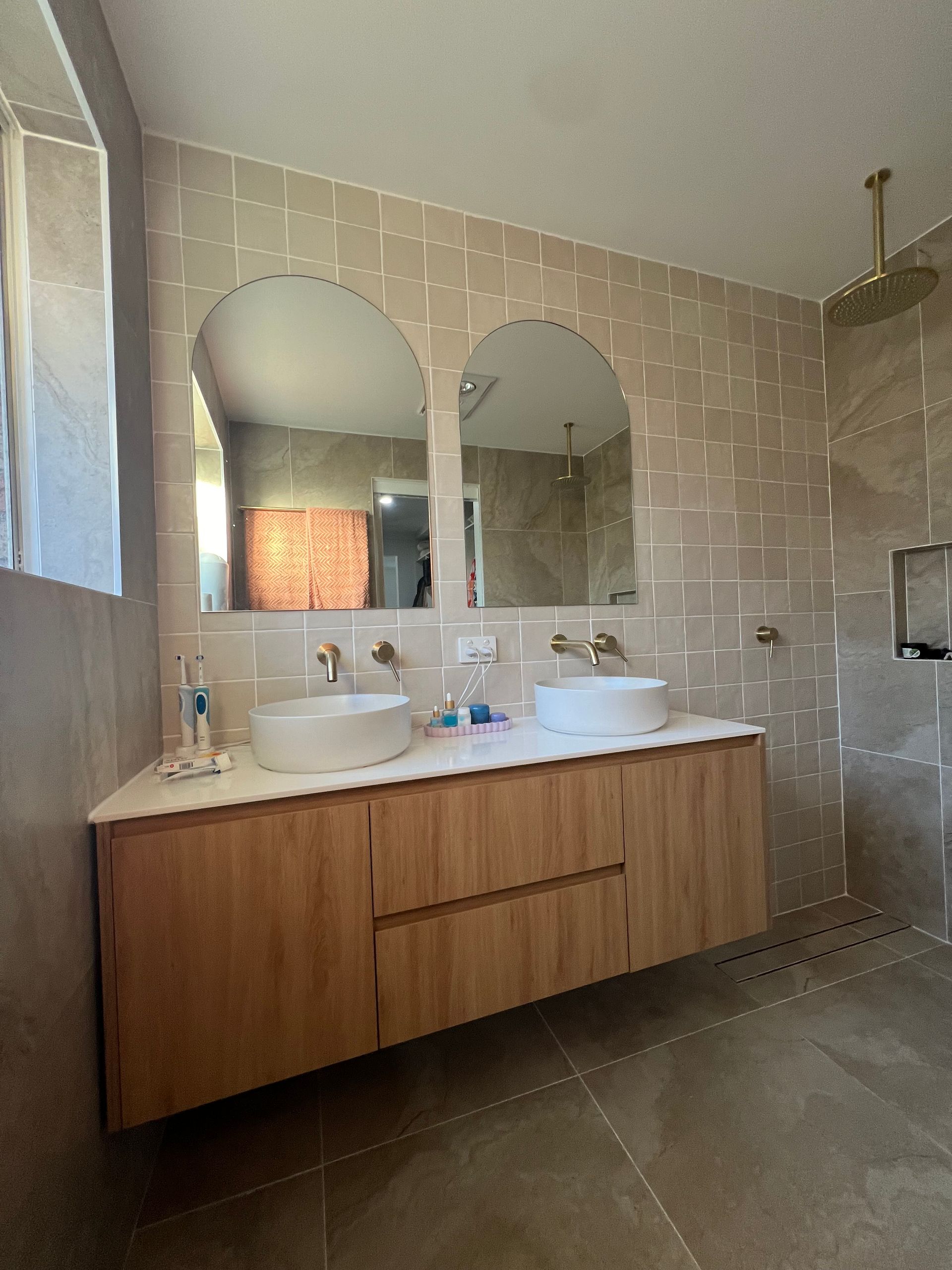 A bathroom with two sinks and two mirrors.