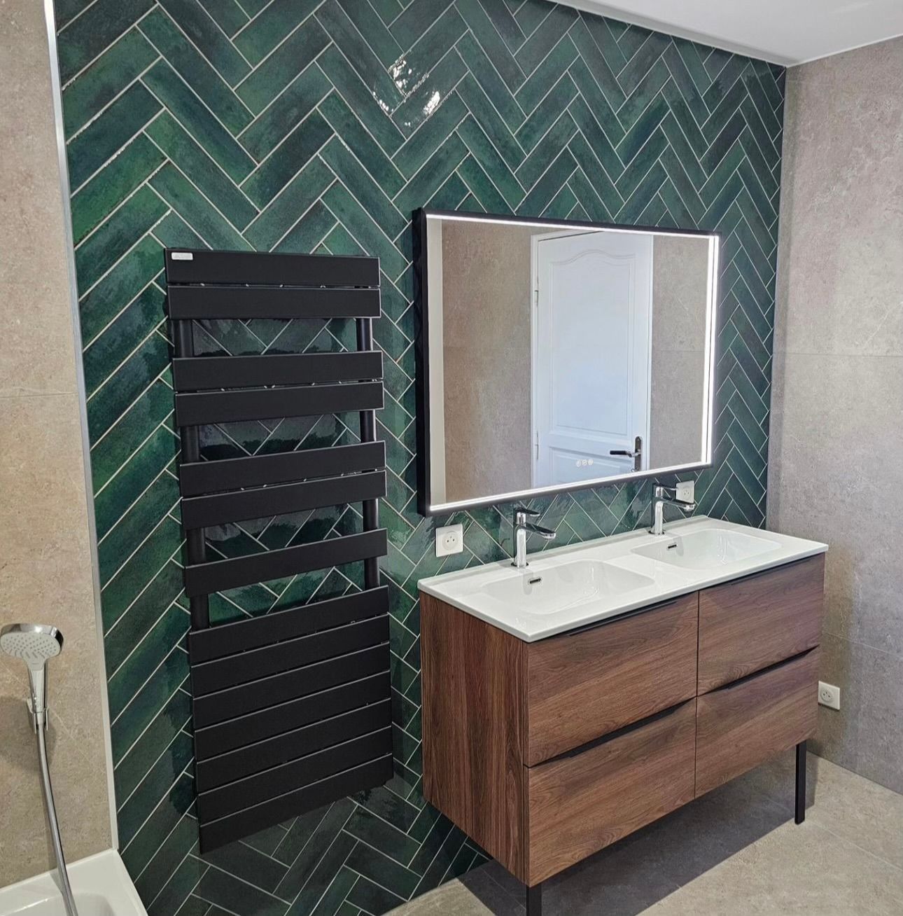 A bathroom with two sinks , a mirror and a towel rack