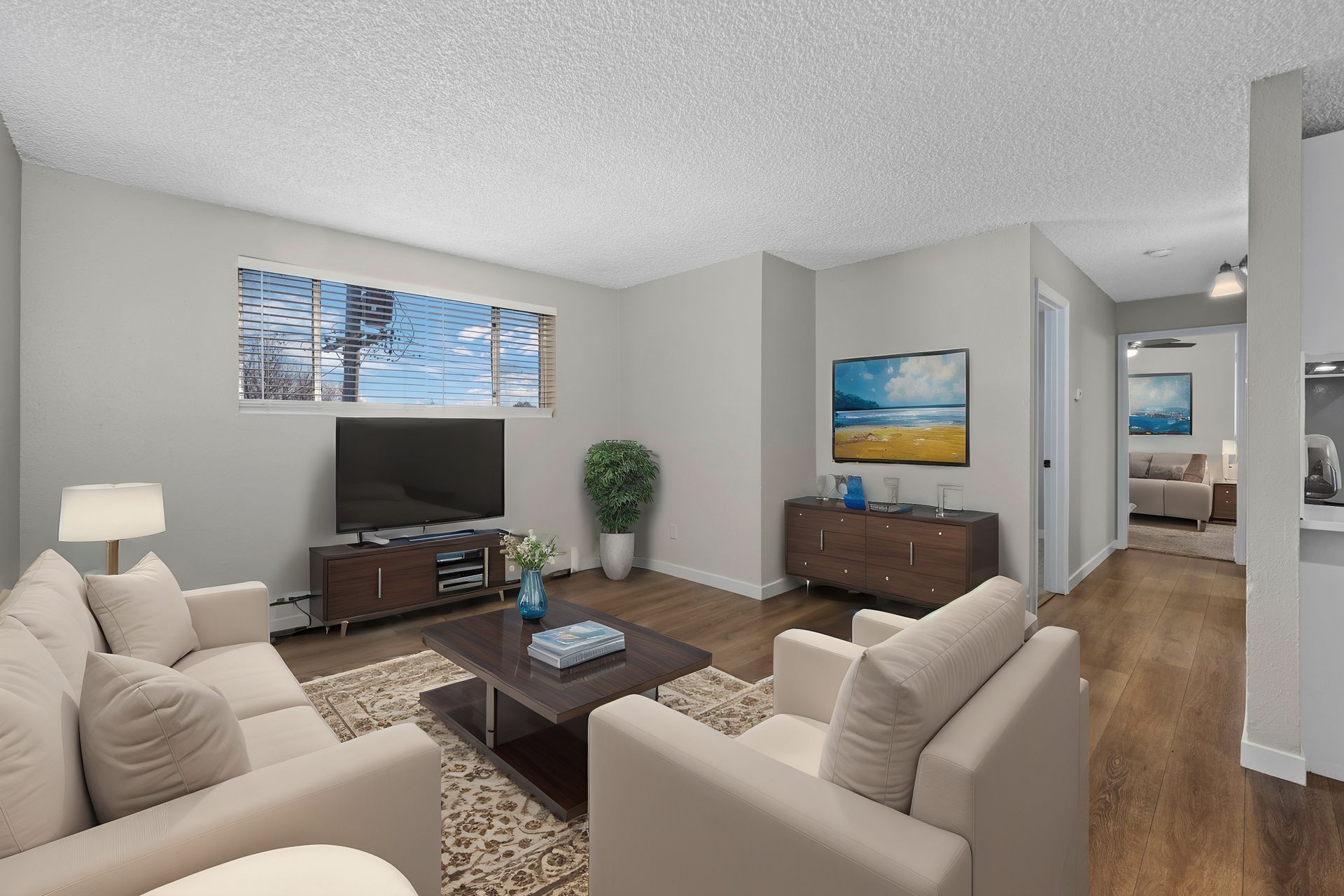 Photo of a living room, showing a bedroom in the background