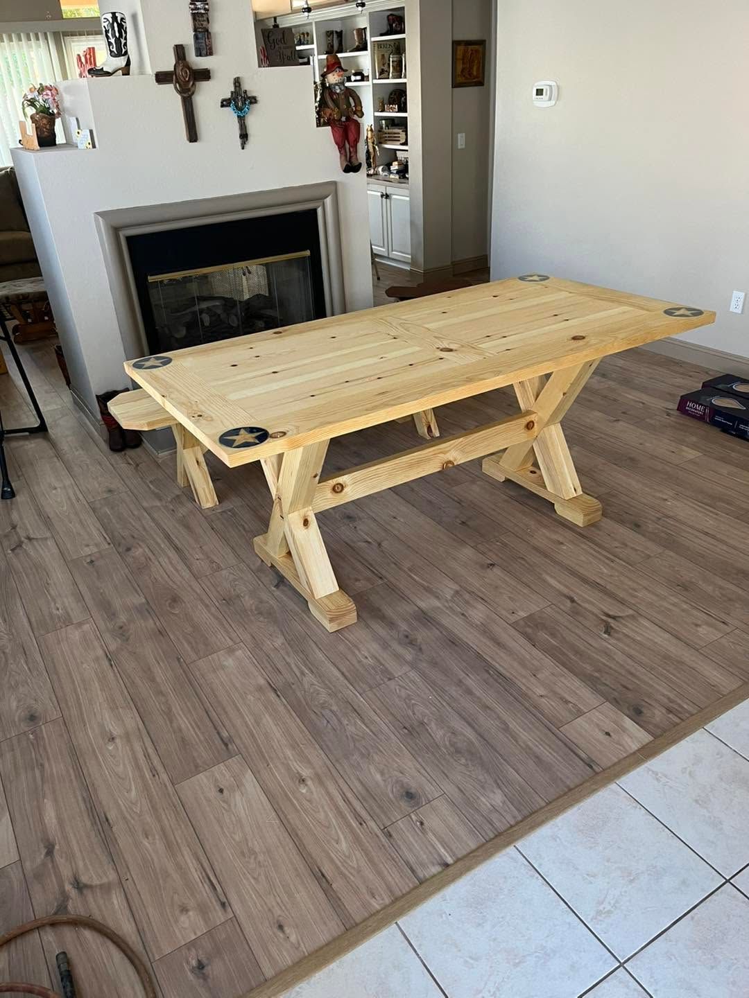 Wooden dining table in a living room beside a fireplace and tiled floor