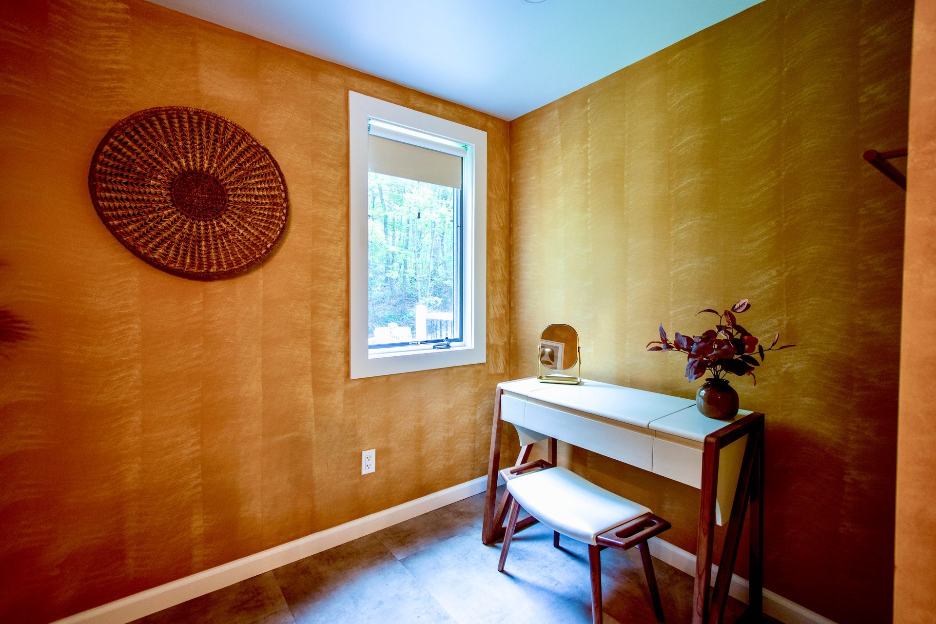 A small room with a desk and a window.