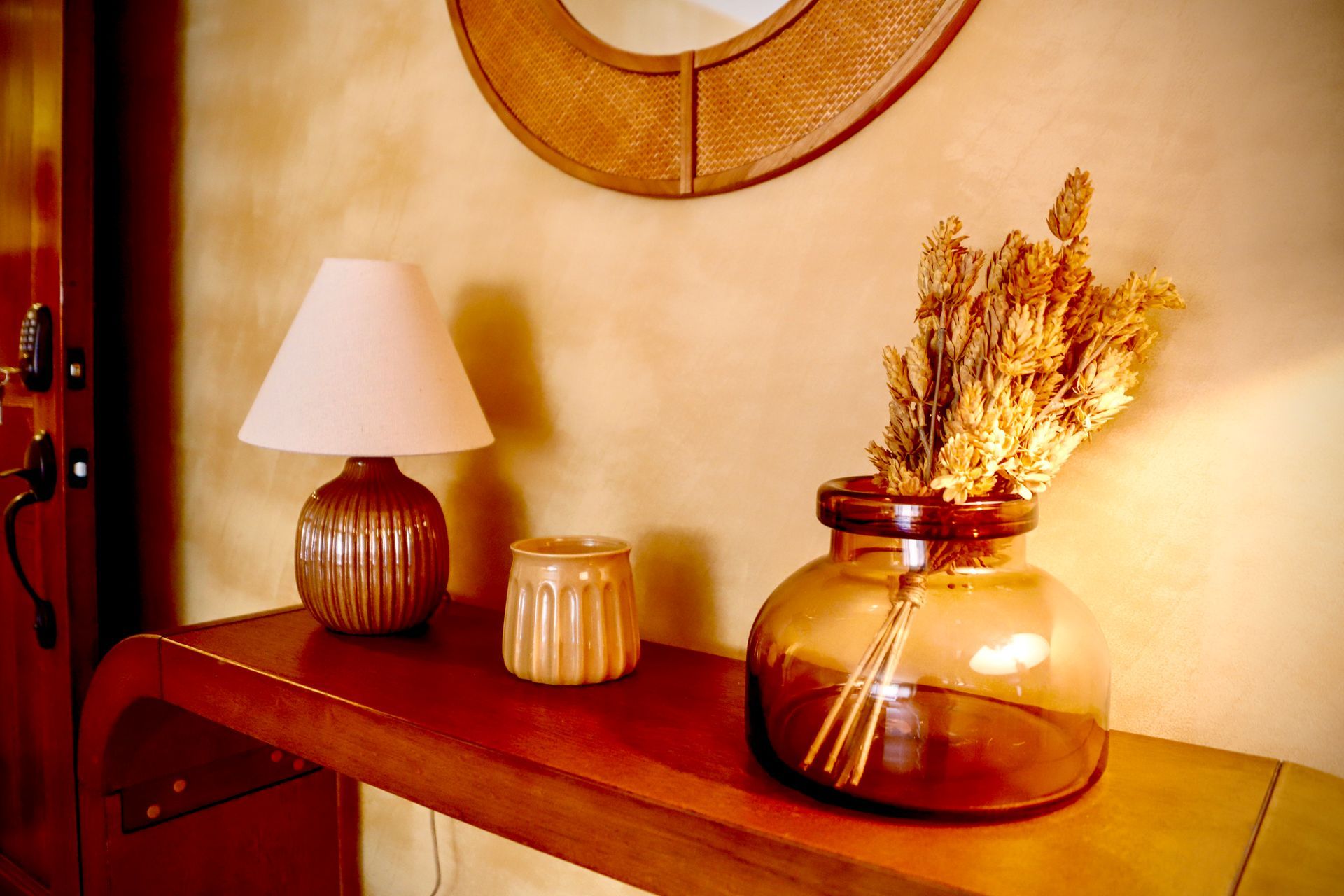 A table with a lamp and a vase on it
