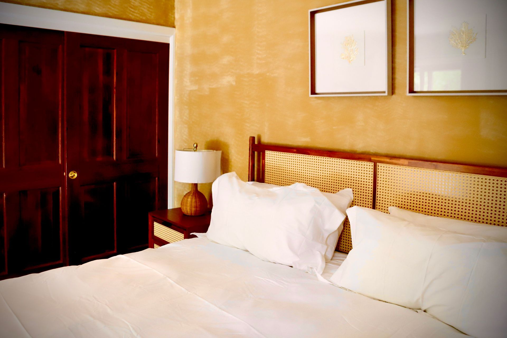 A bedroom with a large bed and a lamp